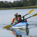 Couple kayaking on late summer date.