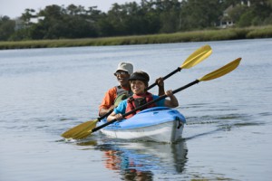 Couple kayaking on late summer date.